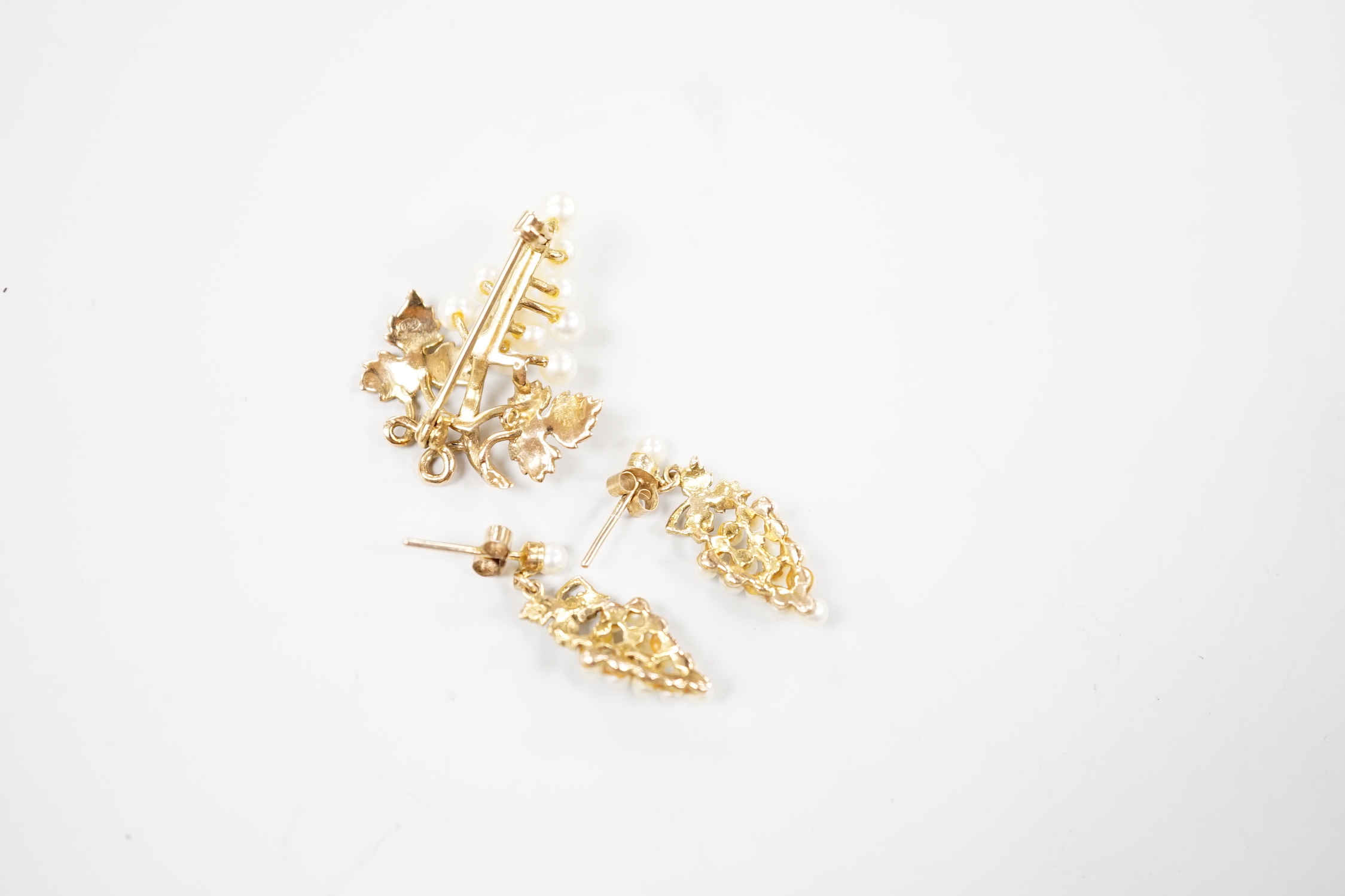 A modern 9ct gold and cultured pearl cluster set suite of jewellery, modelled as a bunch of grapes, comprising a brooch and pair of earrings, gross weight 7.3 grams.